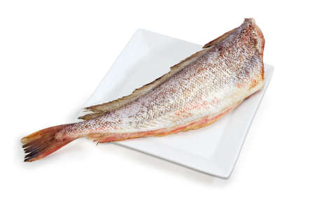 Carcass of the uncooked red cod without heads and purified from fish scale on the large square white...