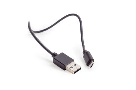 Plugs USB and micro-USB on ends of black cable closeup at shallow depth of field on a white...