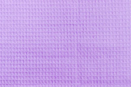 Background of a surface of the purple waffle towel with horizontal layout of pattern 
の写真素材