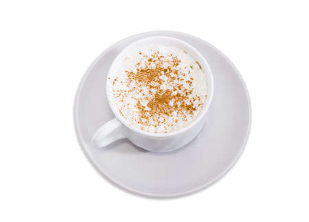 Top view of coffee with foamed cream sprinkled with cinnamon powder in the white cup on the saucer on a white background
の写真素材