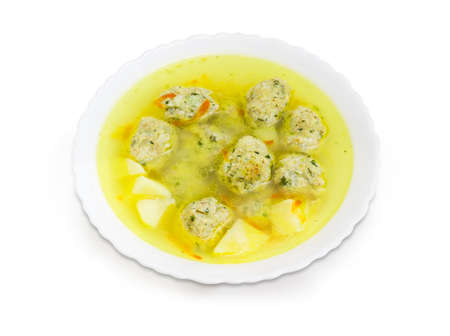 Soup with chicken meatballs in the white dish on a white backgroundの写真素材