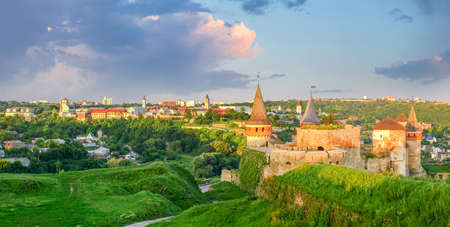View of Old town of the Kamianets-Podilskyi  with medieval fortress on foreground at sunset, Khmelnytskyi oblast, Ukraineの写真素材