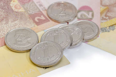 Several new coins denomination of one and two Ukrainian hryvnia of 2018 on the banknotes of same...