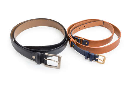 Brown-black belt for women made of synthetic material imitating the leather and black leather belt for men with conventional buckles on a white backgroundの写真素材