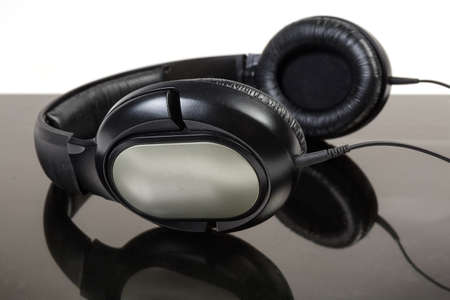 Black wired earspeakers with full size headphonesの写真素材