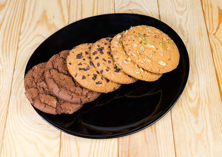 Chocolate chip cookie, cookie with chocolate dough and cookie sprinkled with different seeds on...