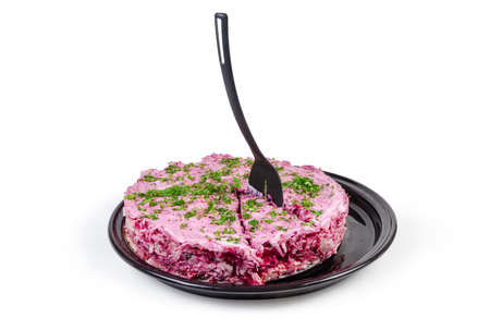 Layered salad of diced pickled herring with boiled grated vegetables, also known as dressed herring...