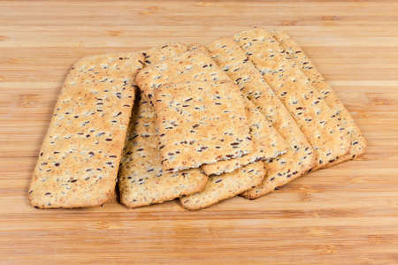 Crisp savory cookies made with whole flax seeds addition on the wooden surface
の写真素材
