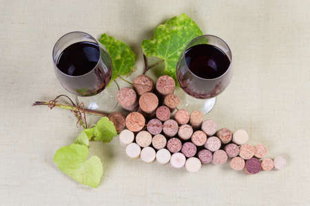 Natural and artificial wine corks, lying in the form of the imaginary grape cluster with natural...