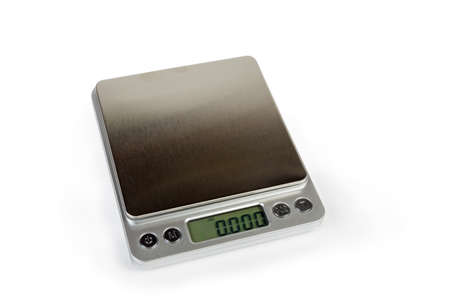 Professional high precision digital table top scales with LCD display and empty stainless steel platform on a white backgroundの写真素材
