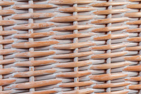 Part of the sidewall of the wooden wicker laundry basket wall with textile bag inside close-up, backgroundの写真素材