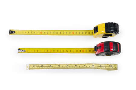 Two metal self-retracting tape measures with flexible metal rulers with metric scales and plastic caseless tape measure with dual inch-centimeter scale on a white background
の写真素材