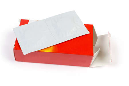 Paper pack of two medicines pills lies on his open red cardboard box on a white background
の写真素材