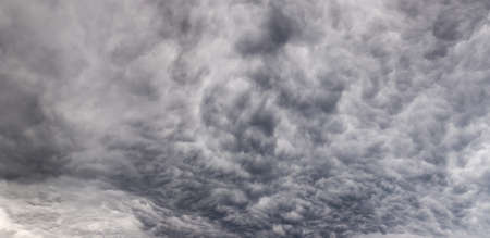 Section of a stormy sky with dense clouds in summer, panoramic view, texture, backgroundの写真素材
