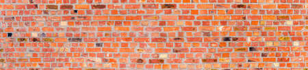 Fragment of the old wall built of red bricks with cracks and spots, wide panoramic view. Texture,...