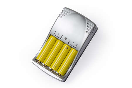 Rechargeable batteries AA size inserted in a smart battery charger on a white background