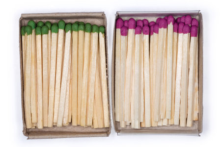 Two completely open cardboard matchboxes with household wooden safety matches with purple and green...