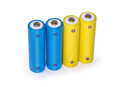 Yellow and blue rechargeable batteries AA size on a white backgroundの写真素材
