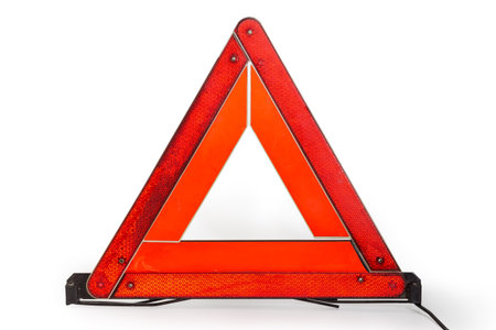 Used warning triangle of fold-able design, made with a red reflective fluorescent material, stand on...