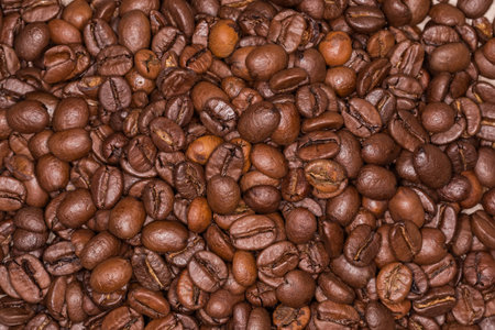 Pile of a roasted coffee beans, top view. Background, texture