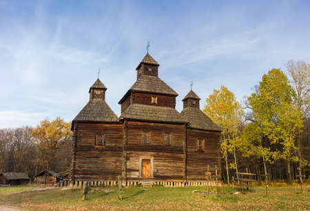 Old wooden church with three tent shaped domes, built of pine logs in the 18th century, side view,...