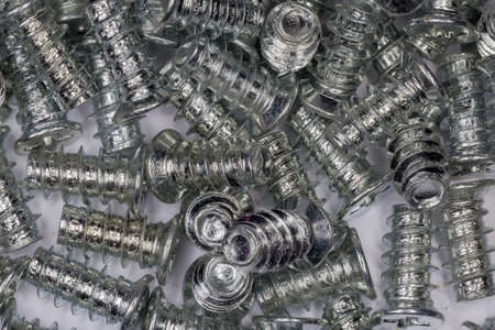 Pile of cylindrical self-threading cross recessed countersunk screws with zinc corrosion coating,...