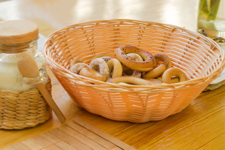 Small crunchy ring shaped cookies, so called sushki in wooden basket on a table, close-up in...