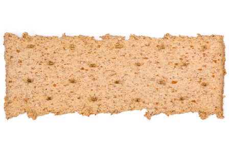 Single dry rectangular flat dietary rye-wheat crispbread on a white background, top view close-up....