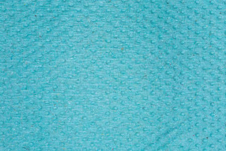 Texture of the surface of gray green unbleached embossed disposable paper towel, top view close-up