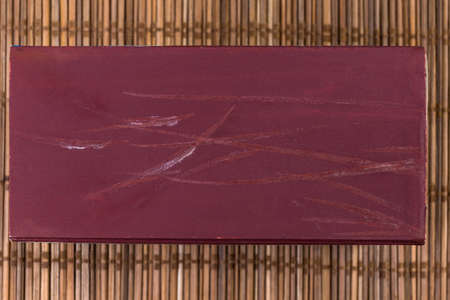 Striking surface of partly used large match box for household matches with ignition marks of...