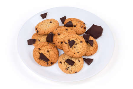 Chocolate chip cookies made with oat flour and broken chocolate pieces on the white dish on a white...