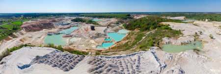 China clay pit with small quarry lakes with turquoise water against the clear sky in summer day, aerial wide panoramic viewの写真素材
