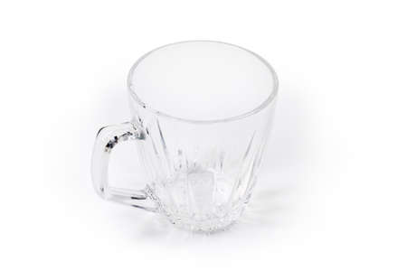 Empty transparent glass cup with handle on a white background