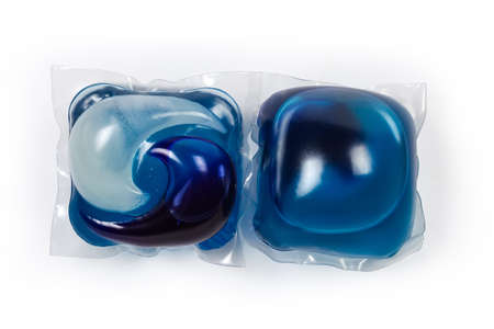 Two blue laundry detergent capsules on a white background, top view