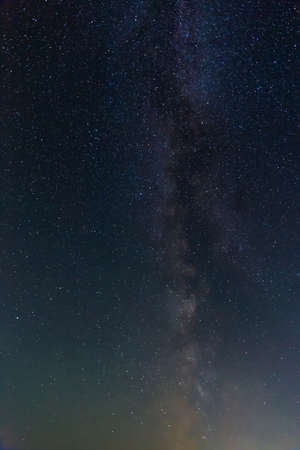 Fragment of night sky above horizon with Milky Way section and many starsの写真素材