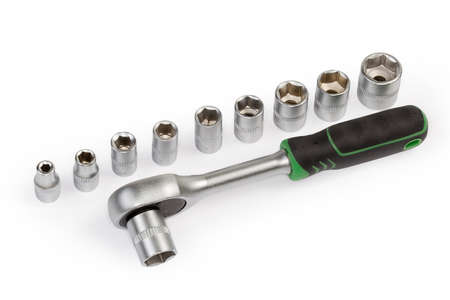 Ratchet wrench with rubberized handle and set of hexagonal sockets different sizes with metric marking on a white backgroundの写真素材
