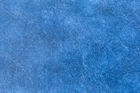 Fragment of the hard cover of book made with blue material remotely imitating leather close-up, texture, backgroundの写真素材
