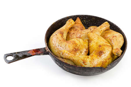 Freshly fried chicken leg quarters crispy outside and juicy on the inside on the old rustic frying pan on a white backgroundの写真素材