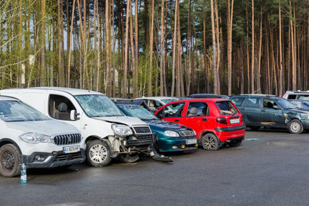 IRPIN, UKRAINE - Apr.27,2022: Civil cars which were shot up by Russian soldiers during evacuation of unarmed peoples from war zone in Russian invasion of Ukraine, car graveyardのeditorial素材