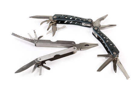 Two different multi-tools with metal handles and partly open various appurtenances on a white...