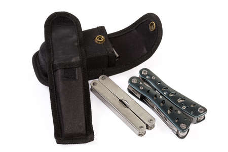 Two different folded multi-tools with metal handles and their open cases on a white backgroundの写真素材