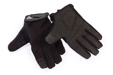 Pair of the black tactical military gloves made with textile and synthetic leathern on a white...