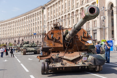 Kyiv, Ukraine - August 22, 2022: Exposition of Russian military equipment destroyed in Russian invasion of Ukraine, wrecked self-propelled howitzer and battle tanksのeditorial素材