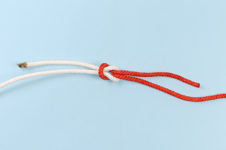 Rope reef knot, also known as square or double knot on a blue backgroundの写真素材