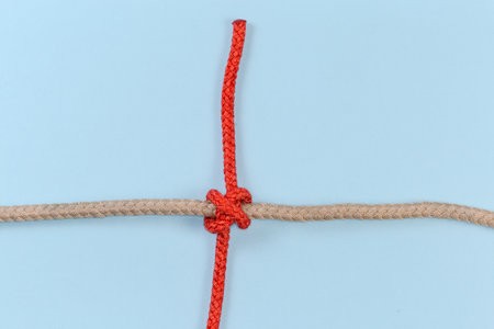 Tightened rope Constrictor knot, used to household binding, tied with an accessory cord around the...
