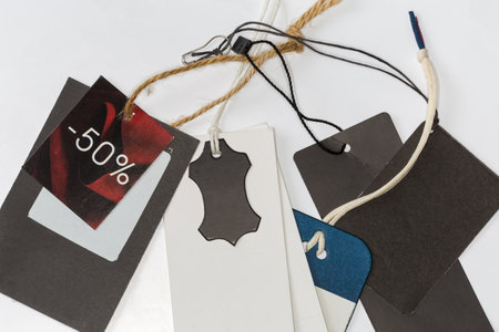 Blank carton clothing swing tags different forms and colors and discount tag on the hanging ropes on...