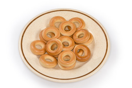 Crunchy ring-shaped small cookies, so called sushki in the Eastern European cuisine on dish on a white backgroundの写真素材