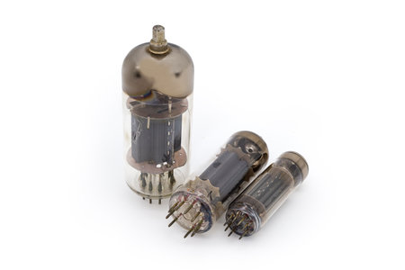 Three different old electronic amplifying vacuum tubes on a white backgroundの写真素材