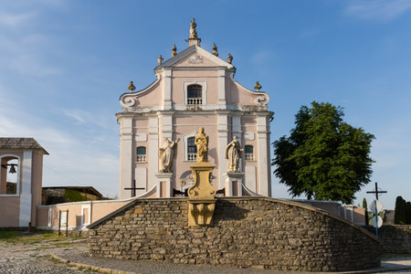 Main facade of the baroque catholic church of the Holy Trinity of Trinitarian Order of the 18th century at sunny spring morning in the Old Town of Kamianets -Podilskyi, Ukraineの写真素材