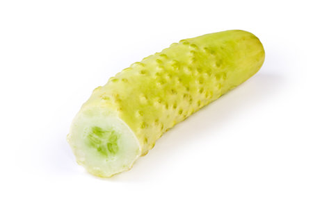 Broken off part of the white cucumber with a view of the insides and seeds on a white backgroundの写真素材